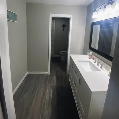 Finished bathroom with vanity, from Jennings Plumbing’s own photographs.