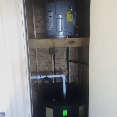 Water heater and pressure tank install in utility closet, from Lee's Plumbing’s own photographs.